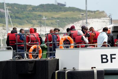 A group of people thought to be migrants are brought in to Dover, Kent, on July 14. PA
