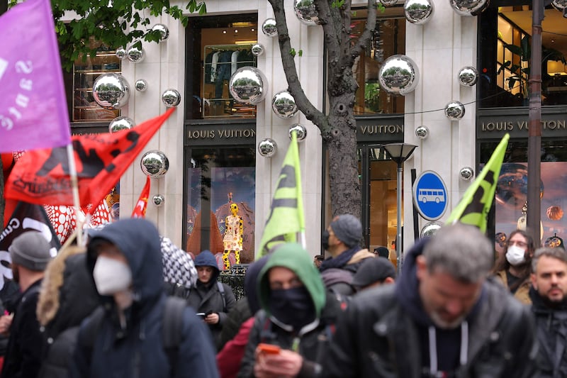 Demonstrators stand in front of the Louis Vuitton store. AFP