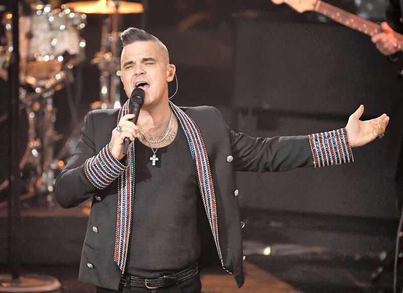 British singer Robbie Williams performs during the "Ein Herz fuer Kinder" (A Heart for Children) charity gala in Berlin on December 7, 2019. (Photo by Jens Meyer / POOL / AFP)