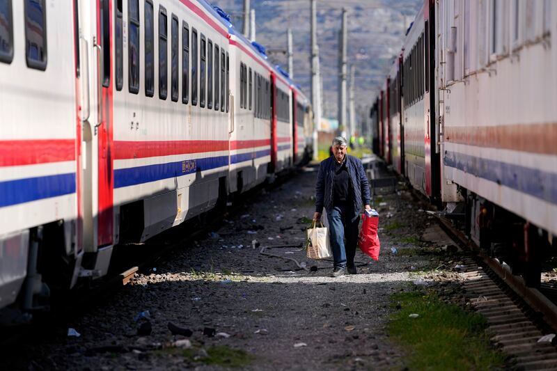 A man walks between trains being using as shelters in Iskenderun, southern Turkey. AP Photo