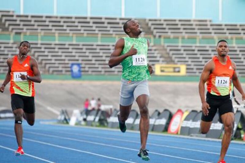 Jamaican runner Usain Bolt crosses the line at the Camperdown Classic 400m men's race in Kingston.