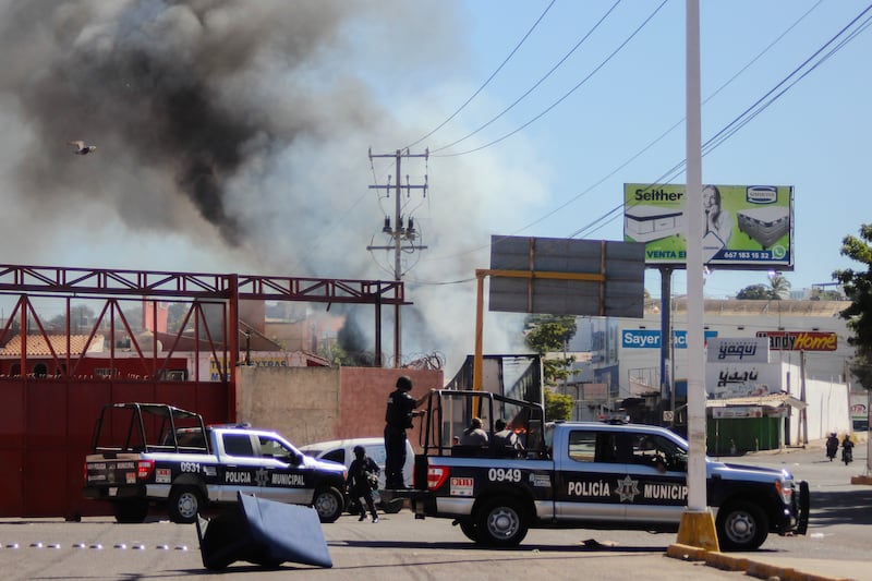 Police arrive after a shop was looted in Culiacan on Thursday. AP Photo