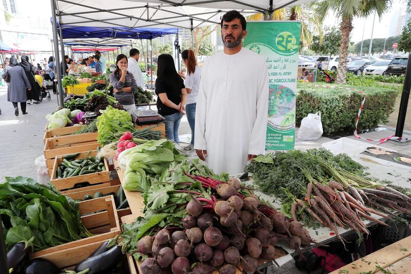 DUBAI , UNITED ARAB EMIRATES , January 18 ��� 2019 :- Rashed Salyem Al Kitby ( center ) selling organic vegetables at the Farmers Market held at the Bay Avenue in Business Bay in Dubai. (Pawan Singh / The National ) For News/Online/Instagram. Story by Patrick