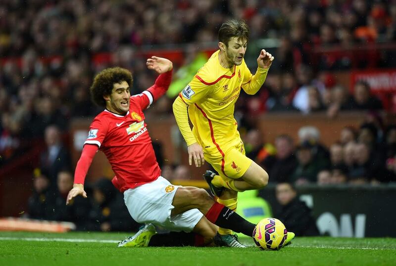 Marouane Fellaini of Manchester United challenges Adam Lallana of Liverpool during their Premier League match on Sunday. Shaun Botterill / Getty Images