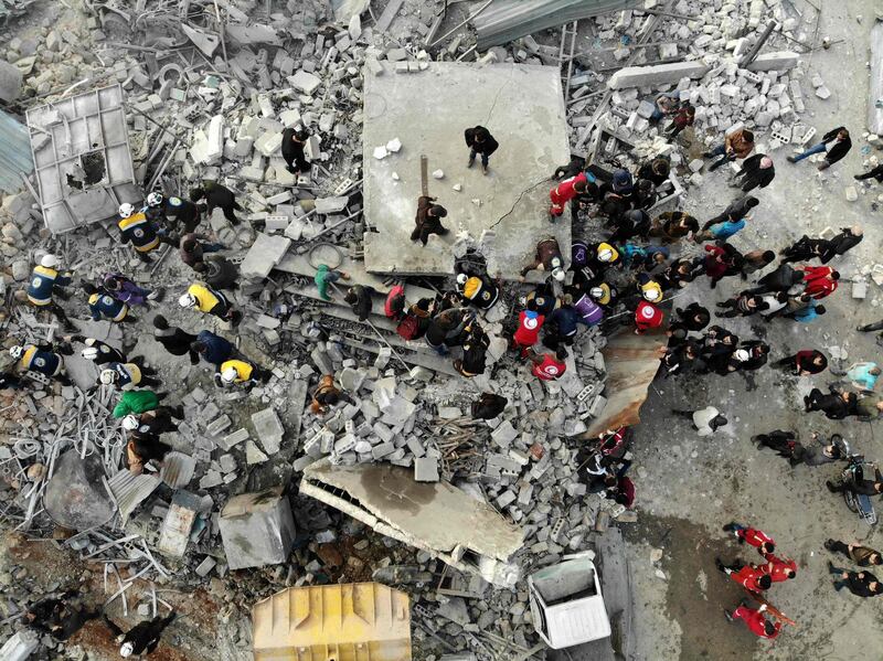 Members of the White Helmets search through the rubble of a building at the site of a regime airstrike on Idlib. AFP