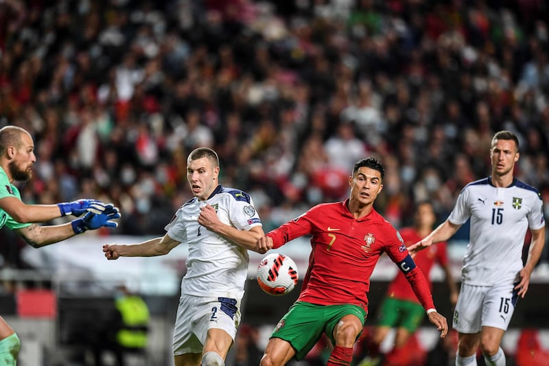 Serbia defender Strahinja Pavlovic fights for the ball with Portugal's forward Cristiano Ronaldo. AFP