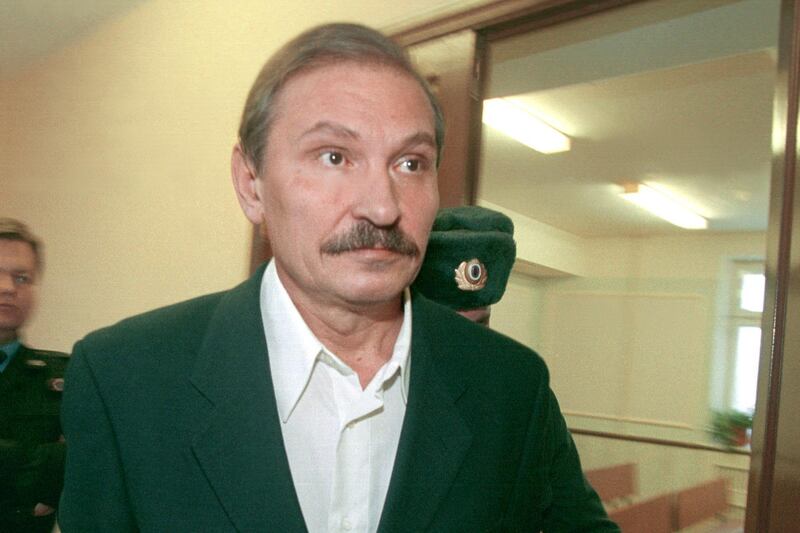 FILE - In this Tuesday, Dec. 19, 2000 file photo, ex-deputy director general of Aeroflot airlines company Nikolai Glushkov leaves the Lefortovsky court escorted by police officers, after the judge refused to release him on bail, in Moscow. British police say on Friday, March 16, 2018 they are treating the death of London-based Russian businessman Nikolai Glushkov as a homicide, after a post-mortem revealed he died from compression to the neck. Glushkov was an associate of Boris Berezovsky, a Russian oligarch and Kremlin critic who died under disputed circumstances in 2013. (Pavel Smertin/Kommersant Photo via AP, file)