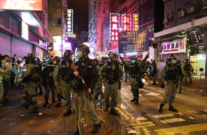 Riot police stand guard during a protest in Mong Kok, Hong Kong. AP Photo