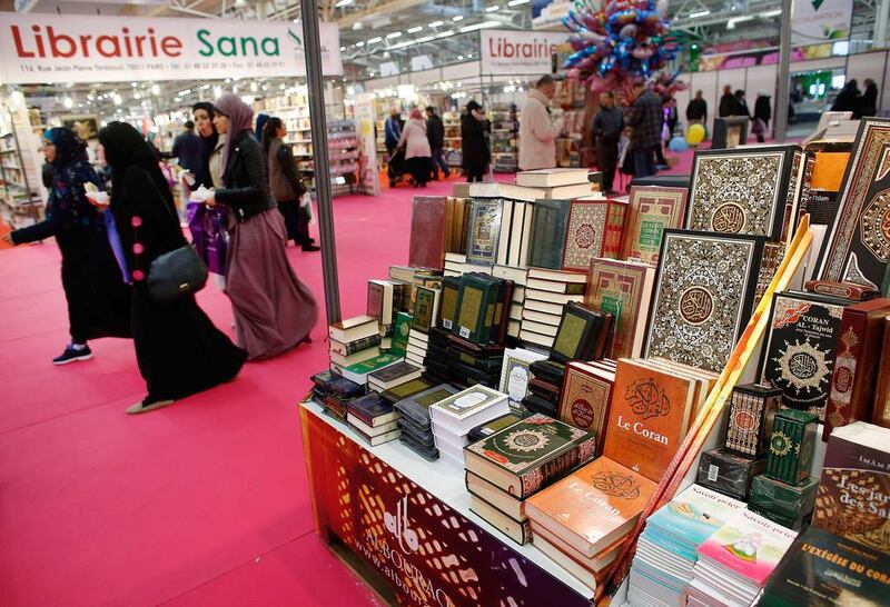 Visitors walk past a bookseller displaying copies of the Quran during the 32nd Annual Meeting of France's Muslims, at Le Bourget Exhibition Centre, north of Paris, on April 3, 2015. Thomas Samson/AFP Photo

