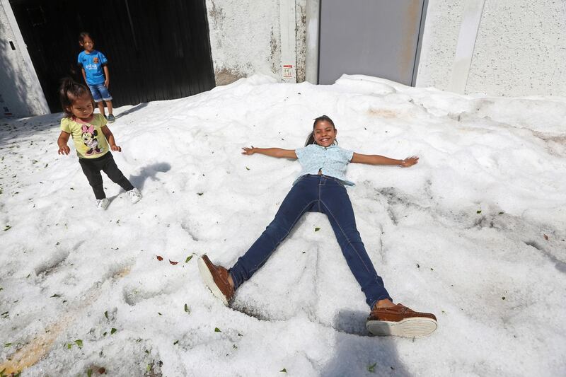 Residents play on top of ice after a heavy storm of rain and hail which affected Guadalajara, Mexico. Reuters