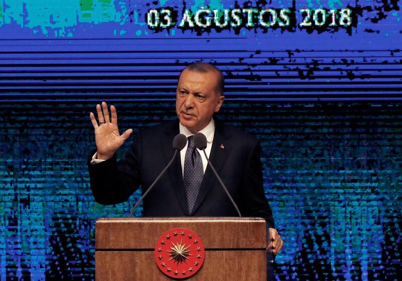 Turkey's President Recep Tayyip Erdogan announces plan of action for the first 100 days of his new presidency, in Ankara, Turkey, Friday, Aug. 3, 2018. (AP Photo/Burhan Ozbilici)