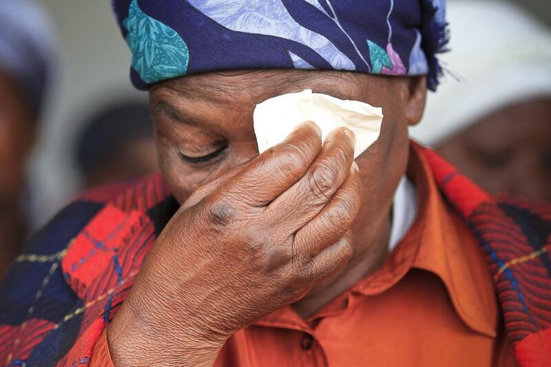  An elderly resident of Qunu wipes away tears as she watches live broadcast of Mandela's funeral. Dai Kurokawa / EPA 