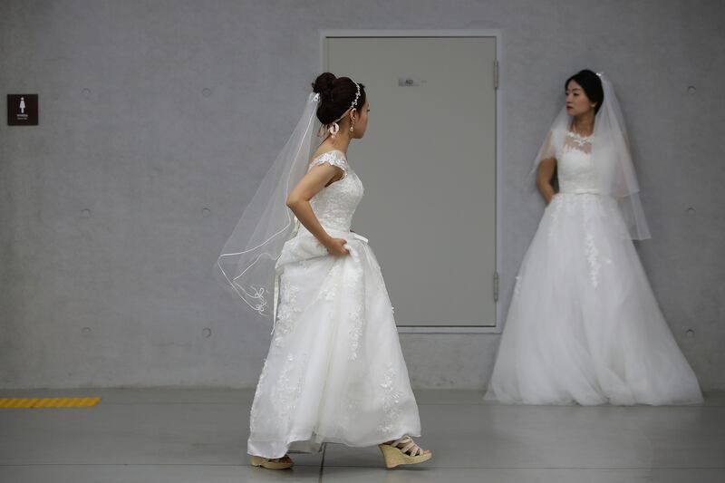 Brides wait for their wedding ceremony. Chung Sung-Jun /Getty Images