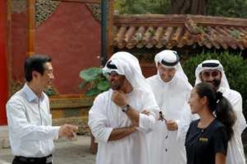 BEIJING, CHINA - August 13, 2009: (2nd left) HH General Sheikh Mohamed bin Zayed Al Nahyan, Crown Prince of Abu Dhabi, Deputy Supreme Commander of the UAE Armed Forces laughs with (left) HE Gao Yusheng, Ambassador of China to UAE, (2nd from right) HE Khaldoun Khalifa Al Mubarak, Chairman of the Executive Affairs Authority, (right) HE Mohammad Ahmad Al Bowardi, Secretary-General of the Executive Council and a tour guide while touring The Forbidden City with a delegation from the United Arab Emirates while on official visit in Beijing. 
(Ryan Carter / The National) *** Local Caption ***  _JC_2155.jpg