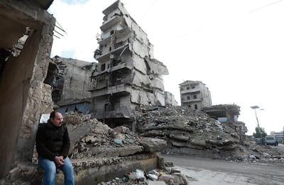 A man sits on the rubble of a building that was destroyed during battles between rebel fighters and regime forces, in the former opposition held district of Salaheddin in the northern Syrian city of Aleppo on February 11, 2019.  three years after the Syrian regime regained, with Russian firepower help, rebel-held territory and took full control of the country's second city. / AFP / LOUAI BESHARA
