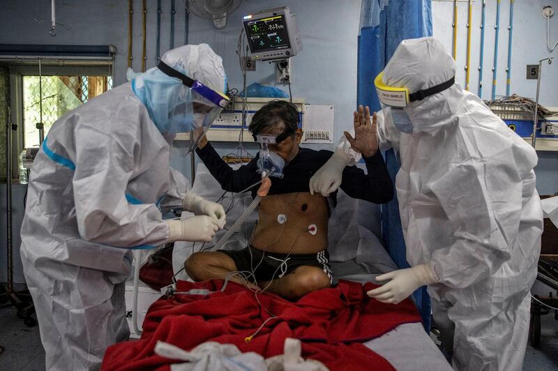 Medical workers wearing PPE tend to a patient suffering from Covid-19 in the ICU at Lok Nayak Jai Prakash hospital, in New Delhi, India. Reuters