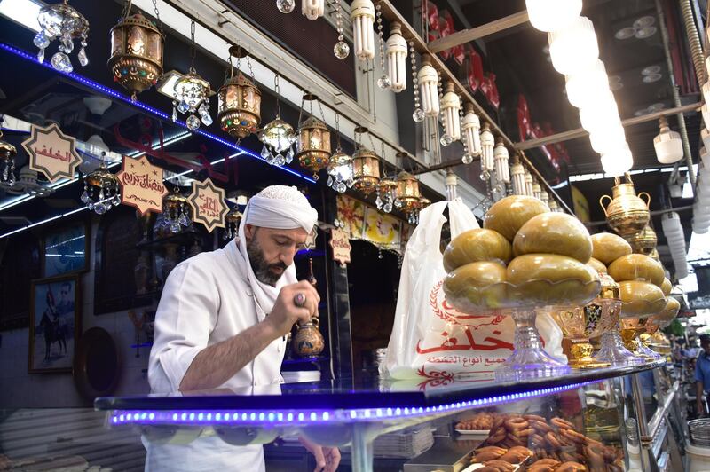 Syrians buy Arabic sweets in one of the old souks of Damascus, Syria.  EPA