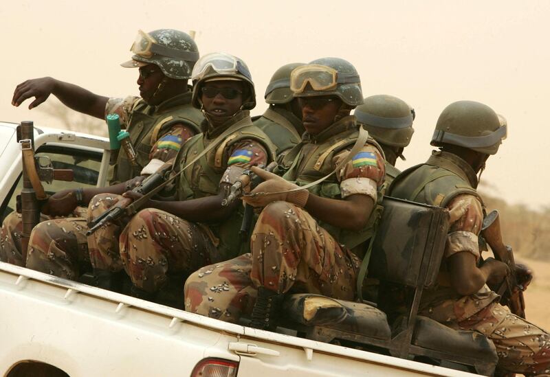 Rwandan soldiers from the African Union Mission in Sudan (Amis) patrol between Al-Fasher, the capital of Northern Darfur, and Kuma, a town to the north-east. Amis is deployed since 2004 in Darfur to bring back peace to this war-torn region. A peace deal was signed on May 05 between one of the three rebel groups and the government of Khartoum. AFP PHOTO/RAMZI HAIDAR (Photo by RAMZI HAIDAR / AFP)