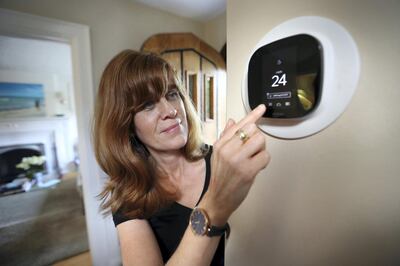 TORONTO, ON - AUGUST, 30    Diana Carradine with Ecobee smart thermostat in her home in the Eglinton and Avenue road area.
 The province is launching the Green Ontario Fund, bankrolled with $377 milion in cap-and-trade revenues, to help homeowners and businesses with programs to reduce their greenhouse gas emissions. The first move is offering free smart thermostats to eligible homeowners, so they can more easily turn down the heat or air conditioning when they're not Ã¢ehome -- saving on natural gas and electricity.        (Richard Lautens/Toronto Star via Getty Images)