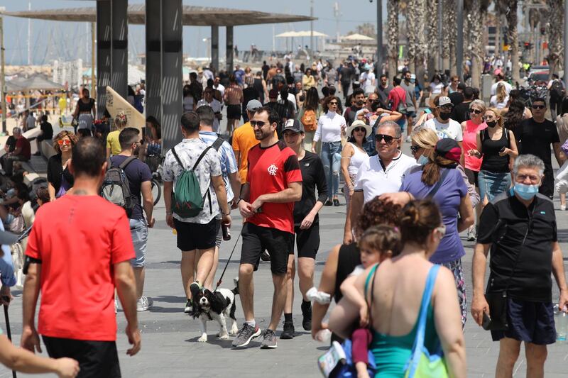 People without face masks enjoy the weather on the beach of Tel Aviv. EPA