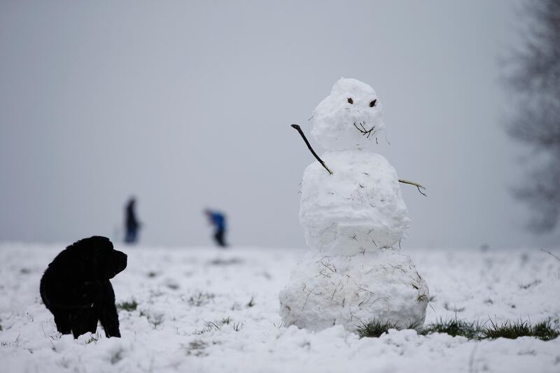 A dog and a snowman are seen on Hampstead Heath in London, United Kingdom. Parts of the country saw snow and icy conditions as arctic air caused temperatures to drop. Getty Images