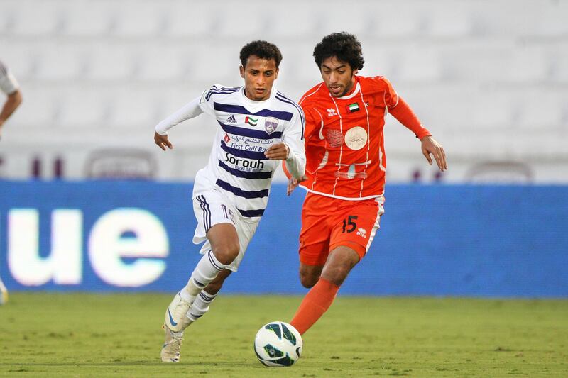 Al Ain, United Arab Emirates, Jan 26, 2013 - Khaled Abdulrahman  (left) from Al Ain fight for the ball against  Ali Khamis Mohamed from Ajman at Tahnon bin Mohamed Stadium.  ( Jaime Puebla / The National Newspaper ) 