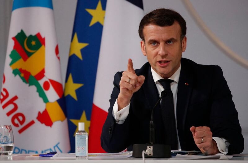 French President Emmanuel Macron speaks after a meeting with leaders of the G5 Sahel, via visio-conference, in Paris, on February 16, 2021. Chad's President Idriss Deby Itno said on February 15, 2021, he would send 1,200 soldiers to the flashpoint "three border" zone between Niger, Mali and Burkina Faso as part of the G5 Sahel group's fight against jihadists in the region. Defence ministers from the regional group, which also includes Mauritania, visited the troops slated for the deployment at their current posting in the Nigerien city of N'Guigmi, near the Chadian border, state television in Chad showed. / AFP / POOL / Francois Mori
