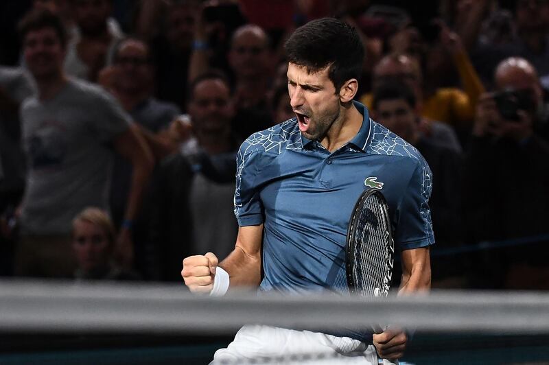 TOPSHOT - Serbia's Novak Djokovic celebrates after winning against Switzerland's Roger Federer at the end of their men's singles semi-final tennis match on day six of the ATP World Tour Masters 1000 - Rolex Paris Masters - indoor tennis tournament at The AccorHotels Arena in Paris, on November 3, 2018. / AFP / Anne-Christine POUJOULAT            
