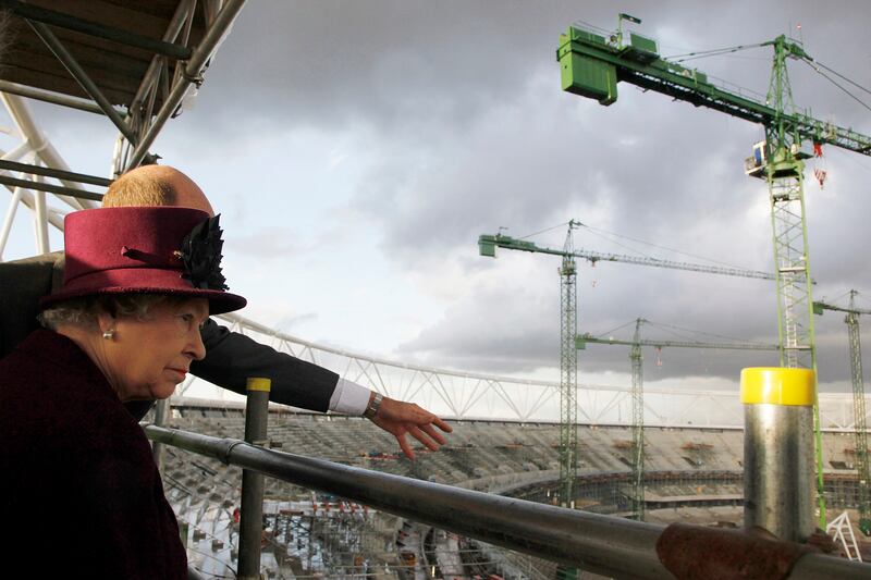Queen Elizabeth II views building progress on the main stadium site in 2009.