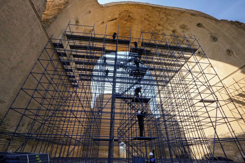 Conservation workers stand on the scaffolding at the Arch of Ctesiphon.