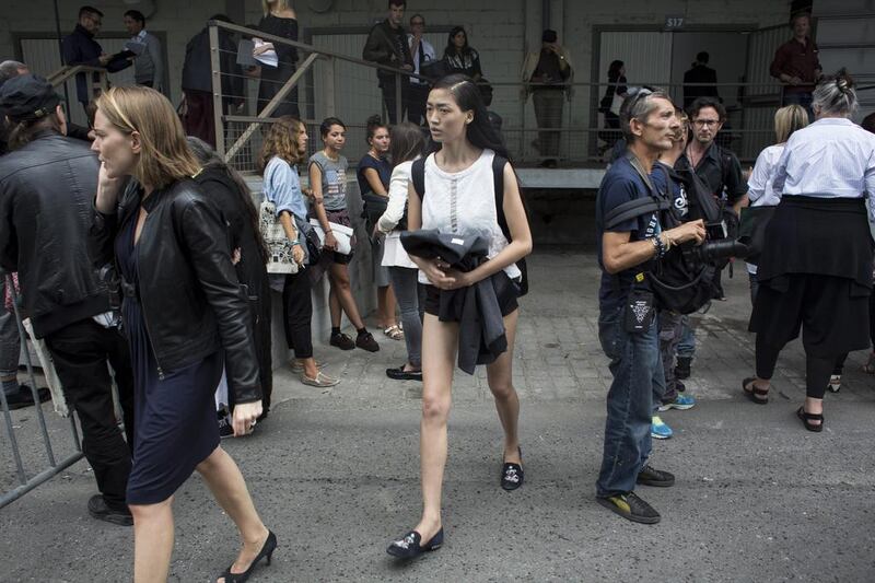 Qiwen Feng, centre, leaves the Dries Van Noten fashion show during the Spring/Summer 2014 Ready to Wear Paris Fashion Week. Yoan Valat / EPA