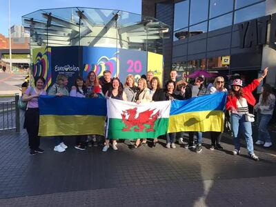 Ukrainians who live in Wrexham hold Welsh and Ukrainian flags outside the Eurovision venue. Photo: Jane Townend