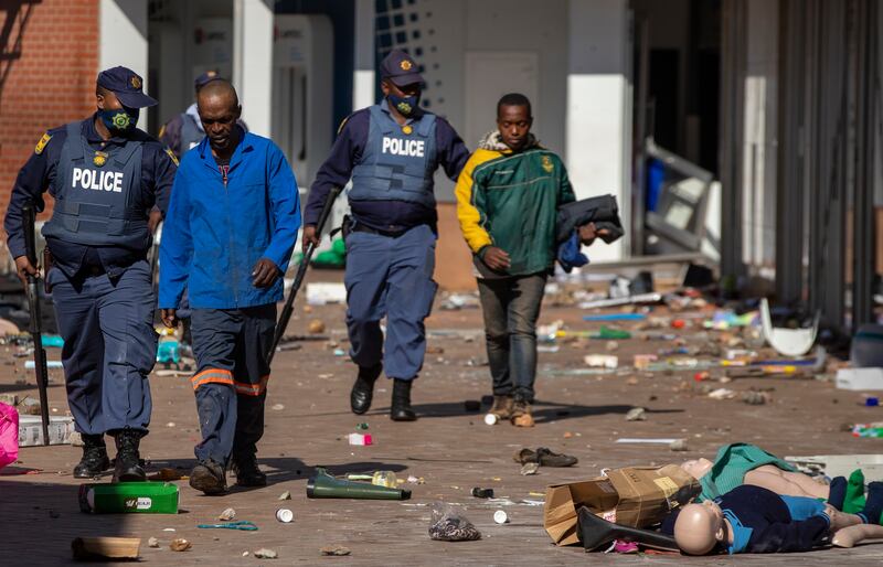 Police officers arrest people suspected of looting in Katlehong, east of Johannesburg.