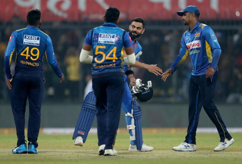 Virat Kohli shakes hands with Sri Lankan players after the match. AP