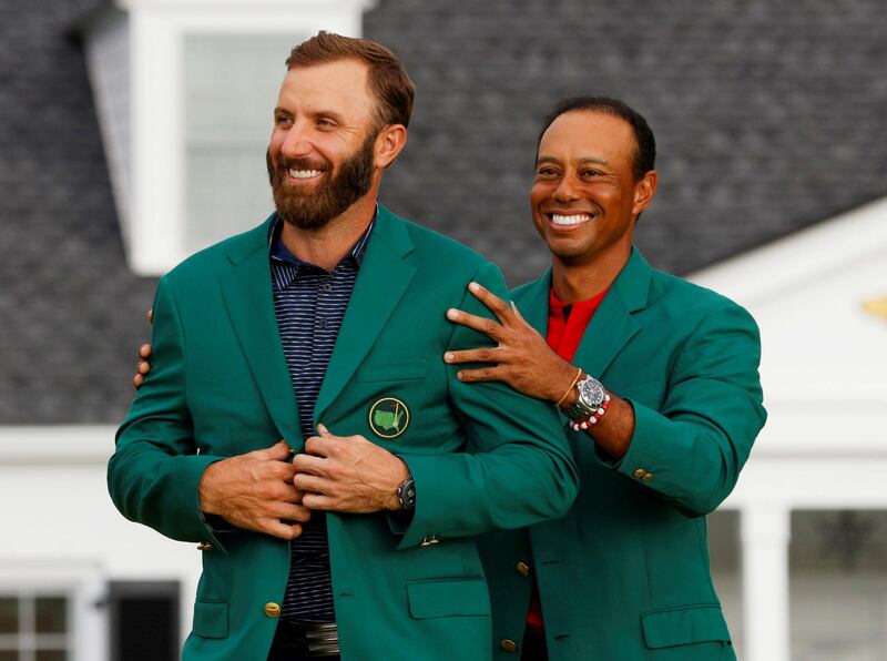 Dustin Johnson is presented with the green jacket by Tiger Woods after winning the Masters. Reuters