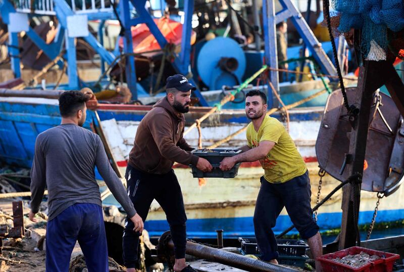 Palestinian fishermen unload their catch at Gaza City's main fishing port. AFP