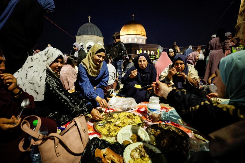 Palestinians eat before they pray. Reuters