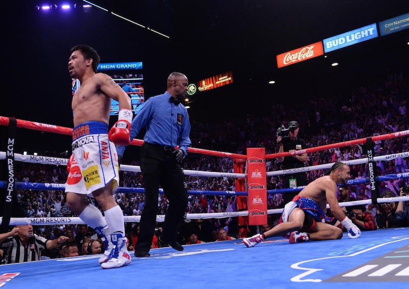 Jul 20, 2019; Las Vegas, NV, USA; Manny Pacquiao (white trunks) and Keith Thurman (red/white/blue trunks) box during their WBA welterweight championship bout at MGM Grand Garden Arena. Mandatory Credit: Joe Camporeale-USA TODAY Sports