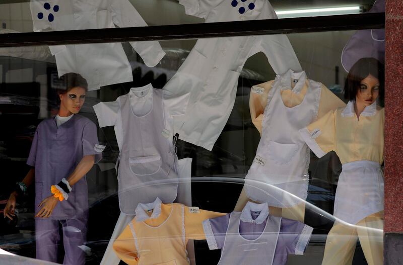 Uniforms for domestic workers are displayed in a shop window in the Lebanese capital of Beirut. AFP