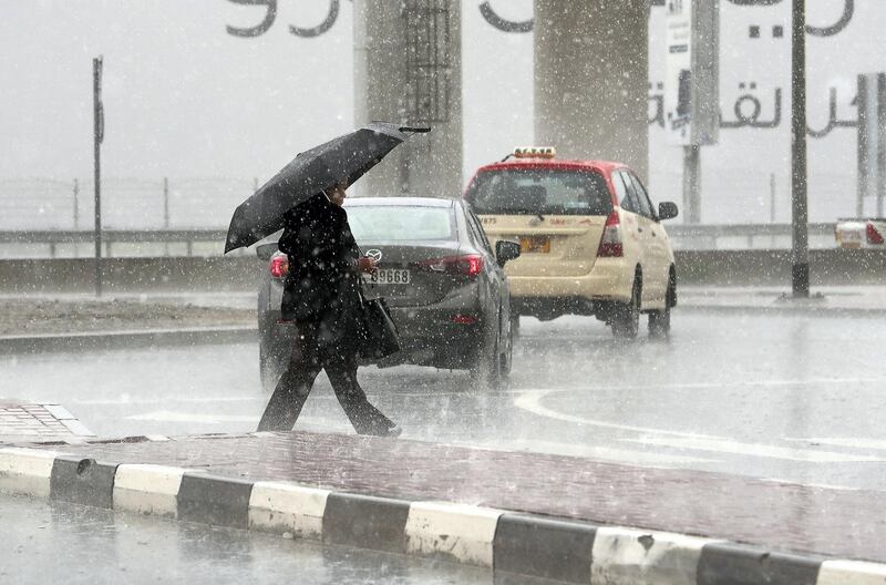 DUBAI, UNITED ARAB EMIRATES , March 22 – 2020 :- One of the commuter caught in the heavy rain in Al Barsha in Dubai. (Pawan Singh / The National) For News/Online/Instagram. 