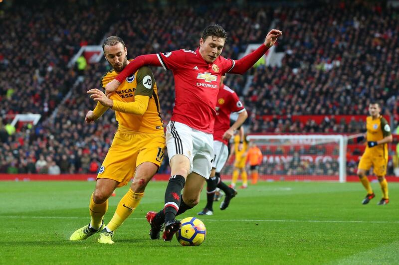 MANCHESTER, ENGLAND - NOVEMBER 25:  Glenn Murray of Brighton and Hove Albion and Victor Lindelof of Manchester United battle for the ball during the Premier League match between Manchester United and Brighton and Hove Albion at Old Trafford on November 25, 2017 in Manchester, England.  (Photo by Alex Livesey/Getty Images)