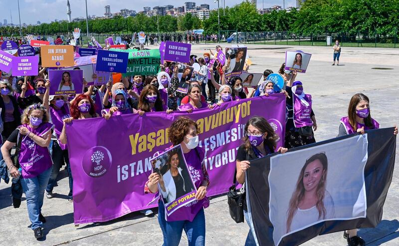 Thousands from across Turkey travelled to Istanbul on Saturday to protest against the country’s withdrawal from the Istanbul Convention, as gender-based violence increases and the erosion of women’s rights continues. Women carry a banner with a picture of Kurd Deniz Poyraz, who was killed by a gunman in an attack at the Peoples' Democratic Party Izmir headquarters on June 17. AFP