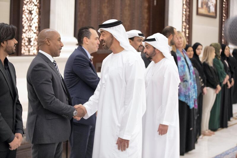 ABU DHABI, UNITED ARAB EMIRATES - May 14, 2019: HH Sheikh Mohamed bin Zayed Al Nahyan, Crown Prince of Abu Dhabi and Deputy Supreme Commander of the UAE Armed Forces (R), greets a doctor who volunteered at at the Special Olympics World Games Abu Dhabi 2019, during an after reception at Al Bateen Palace. Seen with HH Sheikh Hamdan bin Zayed Al Nahyan, Ruler’s Representative in Al Dhafra Region (back). 

( Hamad Al Mansouri for the Ministry of Presidential Affairs )​
---