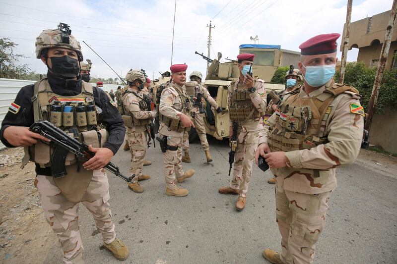 Iraqi forces search the area in Tarmiyah, 35 kilometres (20 miles) north of Baghdad on February 20, 2021, following clashes with Islamic State group fighters. Iraqi security forces clashed with the Islamic State group north of Baghdad, leaving at least five jihadists and two security personnel dead. A joint force of army troops and state-sponsored tribal fighters raided an IS hideout in the leafy plains of Tarmiyah, according to a statement from the military. / AFP / AHMAD AL-RUBAYE
