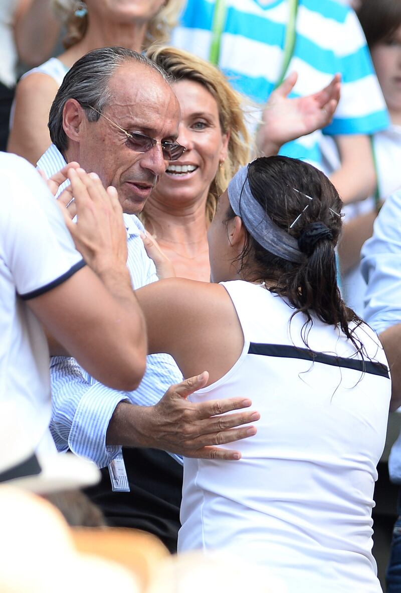 LONDON, ENGLAND - JULY 06:  Marion Bartoli of France celebrates victory with her father Walter Bartoli after the Ladies' Singles final match against Sabine Lisicki of Germany on day twelve of the Wimbledon Lawn Tennis Championships at the All England Lawn Tennis and Croquet Club on July 6, 2013 in London, England.  (Photo by Dennis Grombkowski/Getty Images) *** Local Caption ***  173071139.jpg