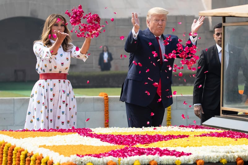 US President Donald Trump and first lady Melania Trump offer floral respects at Raj Ghat, the memorial for Mahatma Gandhi, in New Delhi, India. AP