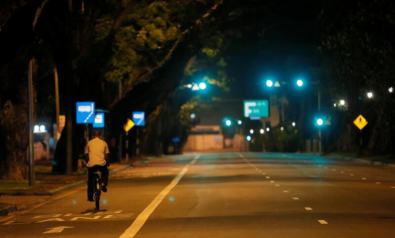 A man rides his bicycle along a road during the curfew after multiple explosions in the country, in Colombo. Reuters