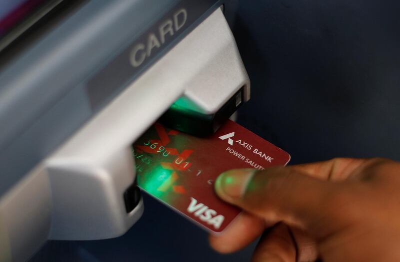 A man uses an Axis Bank automated teller machine (ATM) card in Mumbai, India, January 22, 2018. REUTERS/Danish Siddiqui
