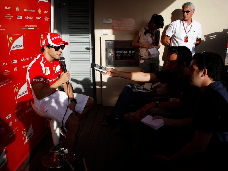 Ferrari Formula One driver Felipe Massa of Brazil talks to the media at the paddock ahead of the Abu Dhabi F1 Grand Prix at the Yas Marina circuit in Abu Dhabi November 10, 2011. REUTERS/Ahmed Jadallah (UNITED ARAB EMIRATES - Tags: SPORT MOTORSPORT) *** Local Caption ***  AJS03_MOTOR-RACING-_1110_11.JPG