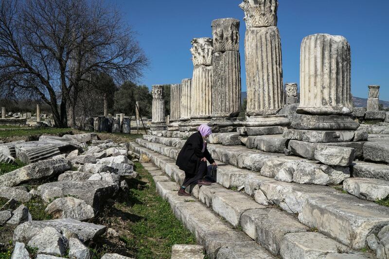 Tayyibe Demirel who is refusing to sell her olive grove to coal mining companies, walks up the stairs of the temple of Hecate in the ancient town of Lagina, near Turgut village, in Mugla province, Turkey. Reuters